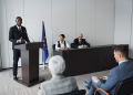 Business presentation featuring a diverse group of professionals discussing at a conference.
