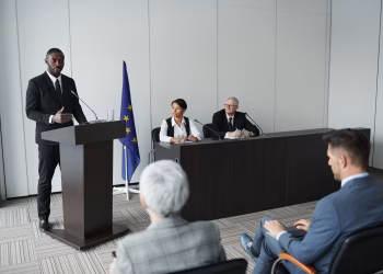 Business presentation featuring a diverse group of professionals discussing at a conference.