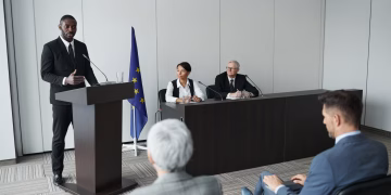 Business presentation featuring a diverse group of professionals discussing at a conference.