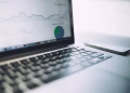 A laptop showing an analytics dashboard with charts and graphs, symbolizing modern data analysis tools.