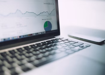 A laptop showing an analytics dashboard with charts and graphs, symbolizing modern data analysis tools.