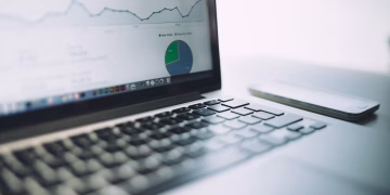 A laptop showing an analytics dashboard with charts and graphs, symbolizing modern data analysis tools.
