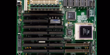 A close-up of a vintage motherboard highlighting microchips and electronic components.