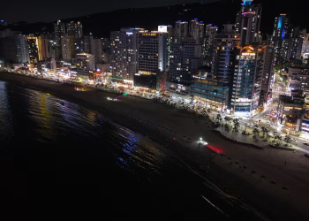 Stunning night view of Busan's illuminated cityscape along the coastline.