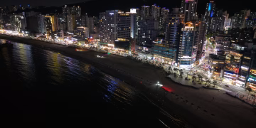 Stunning night view of Busan's illuminated cityscape along the coastline.