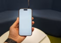 Closeup of a hand holding a smartphone with a blank screen, perfect for app mockups and presentations.