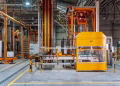 Detailed view of machinery in an operational glass factory in Dar es Salaam.