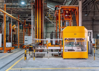 Detailed view of machinery in an operational glass factory in Dar es Salaam.
