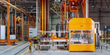 Detailed view of machinery in an operational glass factory in Dar es Salaam.