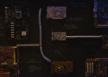 Artistic arrangement of circuit boards and cables symbolizes modern technology.
