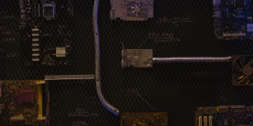 Artistic arrangement of circuit boards and cables symbolizes modern technology.