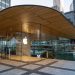 Exterior view of a modern Apple Store in downtown Chicago by the river, showcasing sleek glass architecture.