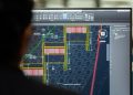 A civil engineer working on a weir design using CAD software on a computer screen in an office setting.
