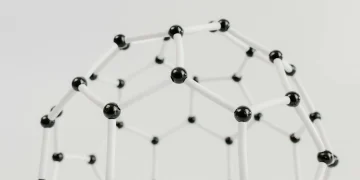 Close-up of a geometric molecular structure model with black and white connections on a light background.