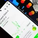 Smartphone displaying stock market app next to U.S. dollar and passport, representing global finance.