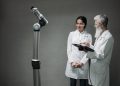 Researchers working with advanced robotics technology in a laboratory setting.