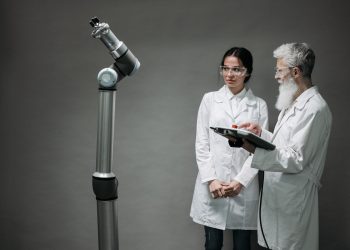 Researchers working with advanced robotics technology in a laboratory setting.