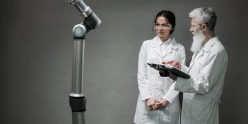 Researchers working with advanced robotics technology in a laboratory setting.