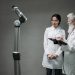 Researchers working with advanced robotics technology in a laboratory setting.