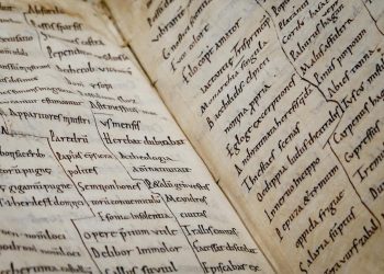 Detailed close-up of an ancient manuscript showcasing Latin text and calligraphy.