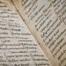 Detailed close-up of an ancient manuscript showcasing Latin text and calligraphy.