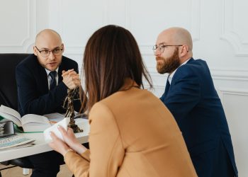 Professional discussion among lawyers in a modern office, focusing on legal matters.