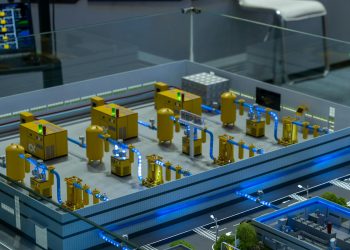 Detailed industrial model display showcasing machinery and systems indoors, emphasizing technology and design.