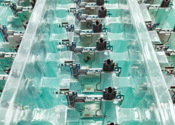 Detailed view of organized electronic circuit boards in a production setting.