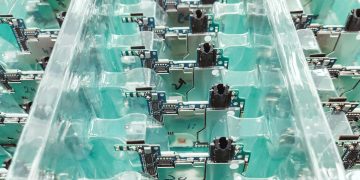 Detailed view of organized electronic circuit boards in a production setting.
