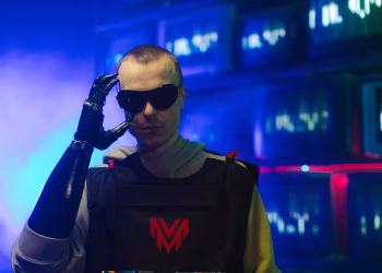 Portrait of an individual in futuristic gear, featuring a prosthetic arm and sunglasses.