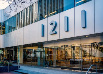 Contemporary architecture of office building facade with glass reflections in Portland, Oregon.