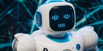 Close-up of a futuristic humanoid robot with a digital face display, representing modern technology.