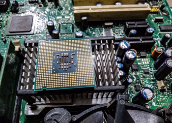 Detailed view of a CPU on a motherboard showcasing electronic components and circuitry.