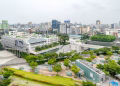 Aerial view of Gwangju cityscape showcasing modern architecture and green spaces.