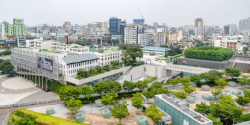 Aerial view of Gwangju cityscape showcasing modern architecture and green spaces.