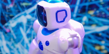 Close-up of a white and blue robot against a dynamic, futuristic tech backdrop.