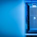 Close-up of a modern server unit in a blue-lit data center environment.