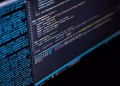 Close-up of a computer screen displaying HTML, CSS, and JavaScript code