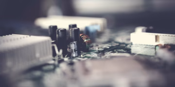 Detailed view of electronic circuit components with a soft focus effect.