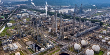 Aerial view of a large industrial oil refinery in Banten, Indonesia with storage tanks and pipelines.