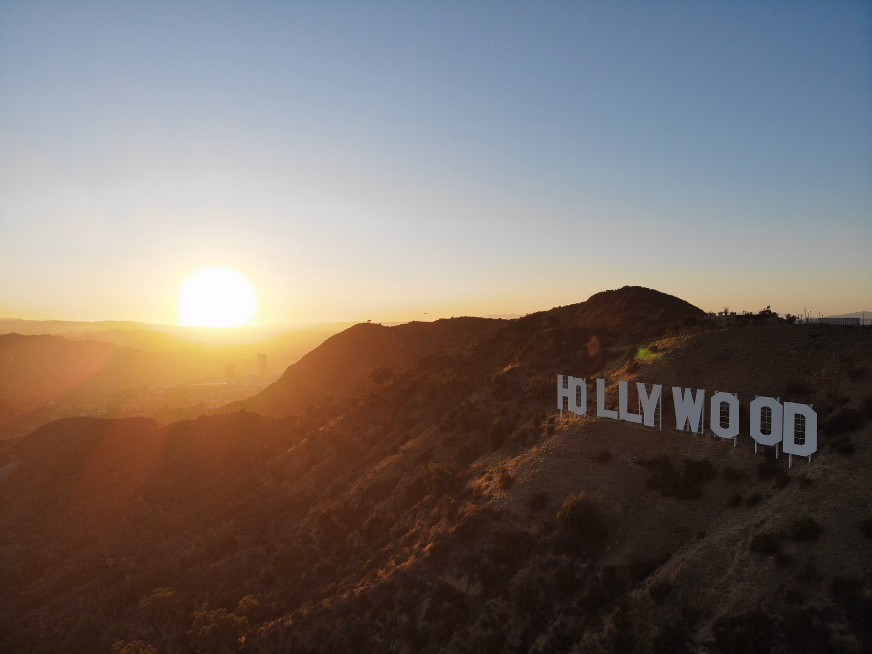 A stunning aerial view of the Hollywood Sign with a sunset backdrop, Los Angeles.