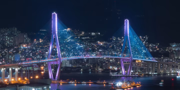 Stunning view of an illuminated cable-stayed bridge in Busan, South Korea at night.