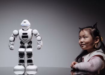 Young Asian girl interacts with a high-tech toy robot, showcasing innovation and curiosity.