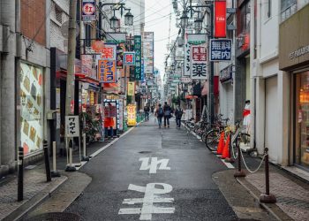 A narrow city street lined with tall buildings