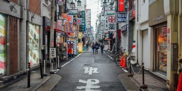 A narrow city street lined with tall buildings