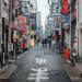 A narrow city street lined with tall buildings