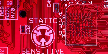 Background of modern colorful printed board of digital device with electric circuits and written words with numbers on red surface