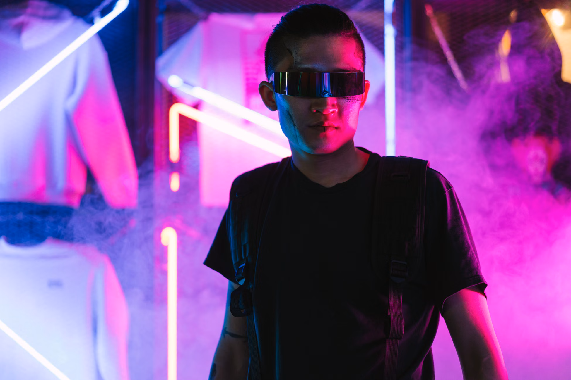 Futuristic man in neon-lit environment wearing sunglasses, exuding cyberpunk style.