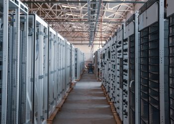 server room aisle with metal equipment racks