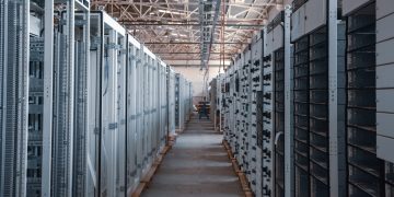 server room aisle with metal equipment racks
